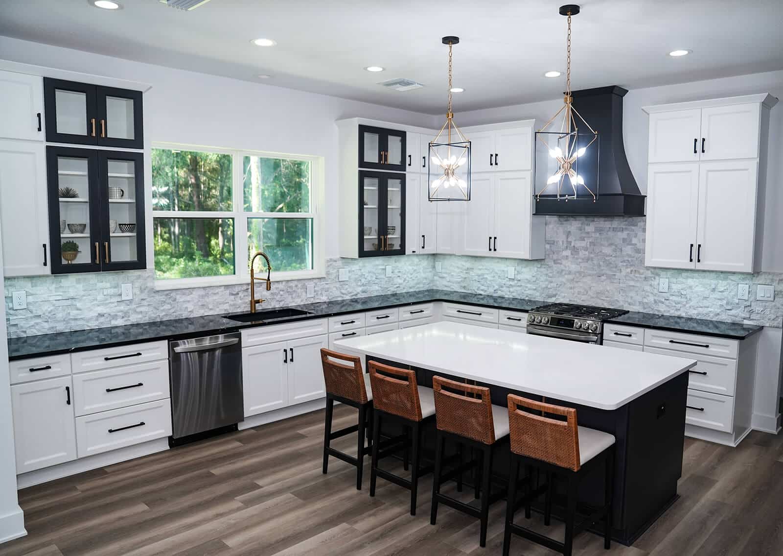 marino-family-kitchen Modern white kitchen with contrasting black accents, large center island, and statement lighting by Deem’s Kitchens & Counters in Pasco County, Florida.