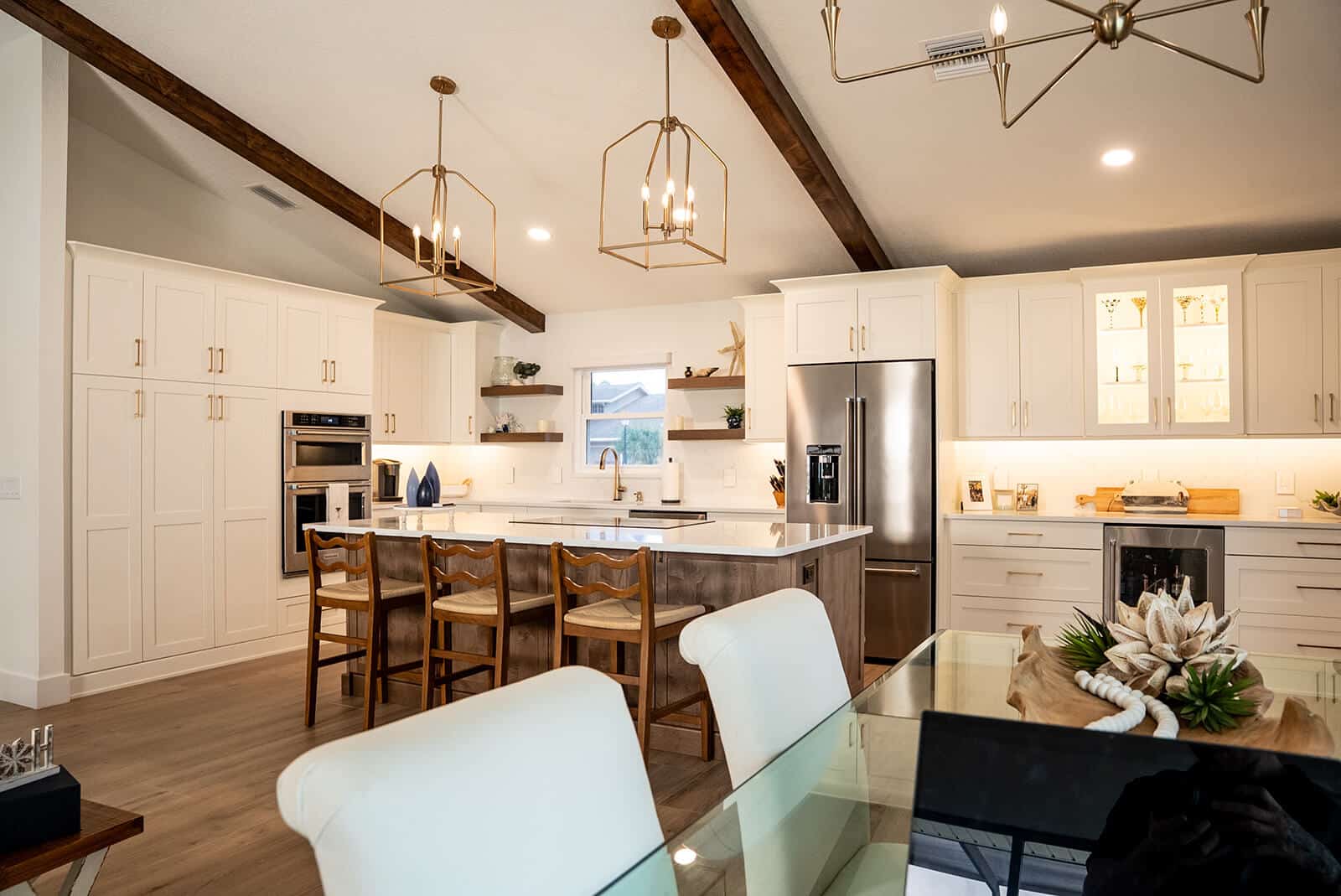 rathgeb-family-remodel Transitional kitchen remodel with vaulted ceiling, exposed beams, and two-tone cabinetry by Deem’s Kitchens & Counters in Pasco County, FL.