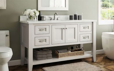 A modern white bathroom vanity from Deem's Outlet features a sink, faucet, and mirror above. Towels, a basket, and toiletries are neatly arranged below. The vanity sits beside a toilet and bathtub, bathed in natural light from a window.